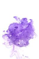 Purple ink dropped in to water isolated white background. Abstract color dissolving in water photo
