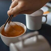 The Artful and Elegant Preparation of Tea Using Honey and Chopsticks in Your Home photo