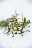 Dried Herbal Tea Leaves Arranged on a Light and Elegant Surface for a Refreshing Experience photo