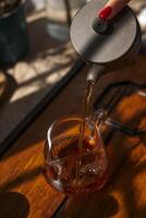 Pouring hot tea into a beautiful cup on a cozy afternoon adds a touch of tranquility photo