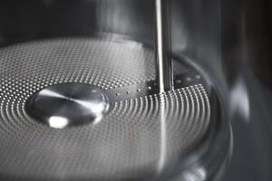 A closeup of a modern kitchen appliance component highlighting intricate design and craftsmanship photo