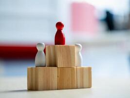 Leadership dynamics wooden figures representing teamwork office conceptual art indoor close-up view photo