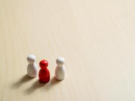 Group dynamics among figurines minimalist setting conceptual art soft lighting photo
