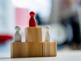 Leadership dynamics in business wooden figurines on blocks office setting conceptual visualization photo