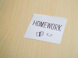 Homework reminder note study materials on student desk in indoor learning environment photo