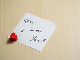 Close-up view of heartfelt love note with red heart personal message and emotional connection photo