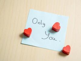 Romantic gesture heart-shaped tokens on note home digital intimate setting close-up love expression photo