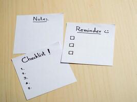 Organizing your life checklist notes and reminders on a wooden table home office conceptual view photo