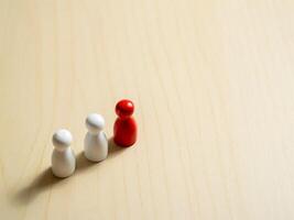 Leadership and team dynamics the red pawn among white pawns in a studio setting photo