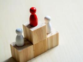 Leadership dynamics red and white figures on blocks conceptual business environment tabletop view photo