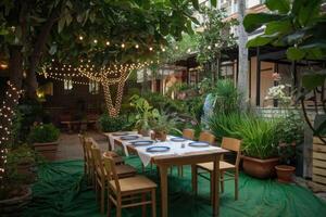 Elegant garden party table setting with string lights illuminating the lush greenery photo
