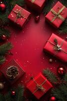 Christmas gifts, ornaments, and pine branches creating festive border on red background photo