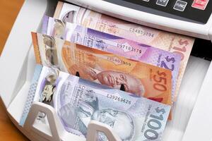 Barbadian dollar in the counting machine photo