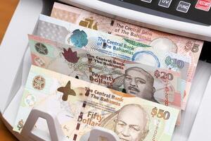 Bahamian dollar in the counting machine photo