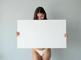 Minimalist composition of a woman holding a blank white board in a bright setting, perfect for mockups and branding visuals photo