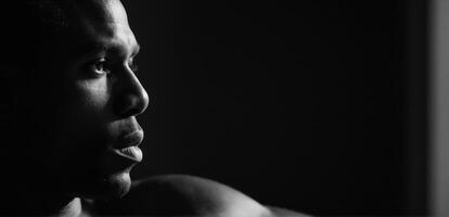 A man in black and white looking away from the camera photo
