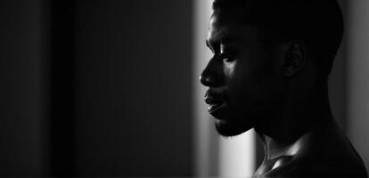 A black and white photo of a man in a room