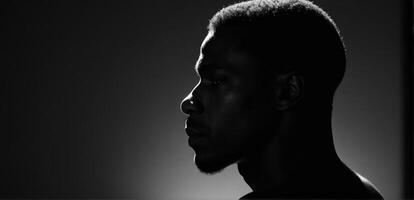 A black man in silhouette against a white background photo
