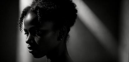 A black woman is standing in the shadows photo