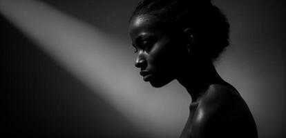 A black and white photo of a woman in the shadows