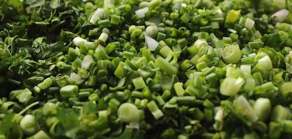 Layer of freshly chopped greens and onion closeup angle view photo