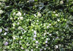 Texture Of Flat Layer Of Small Green Onion Pieces After Chopping photo