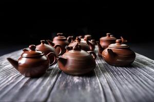 An Elegant Collection of Exquisite Traditional Teapots Beautifully Displayed on a Wooden Table photo