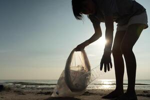 Save ocean. Volunteer pick up trash garbage at the beach and plastic bottles are difficult decompose prevent harm aquatic life. Earth, Environment, Greening planet, reduce global warming, Save world photo