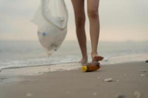Save water. Volunteer pick up trash garbage at the beach and plastic bottles are difficult decompose prevent harm aquatic life. Earth, Environment, Greening planet, reduce global warming, Save worl photo