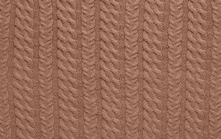 Texture of smooth knitted sweater with pattern. Handmade knitting wool or cotton fabric texture. Background of Large knit pattern with knitting needles or crochet. Mocha Mousse colour of 2025 year photo