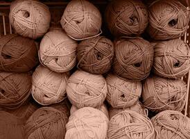Colorful of Yarn Balls Wool in a Fabric Shop. Background from colored acrylic yarn. Skeins of thread close-up. Materials for needlework, for knitting and crocheting. Mocha Mousse colour of 2024 year photo
