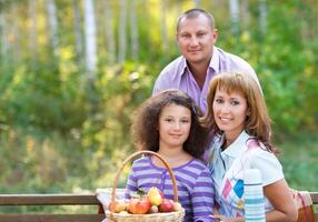 Happy family with daughter on autumn picnic photo