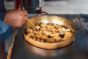 Deep fried dough stick, chinese style in hot oil. photo