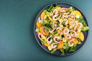 Healthy salad with shrimp prawns, persimmon and green salad. photo