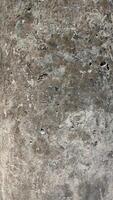 Abstract texture of concrete surface with varied shades and imperfections. photo