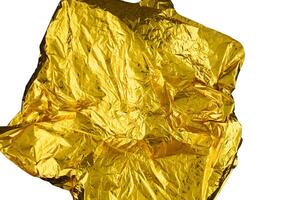 Texture of crumpled gold foil paper on a white background. photo