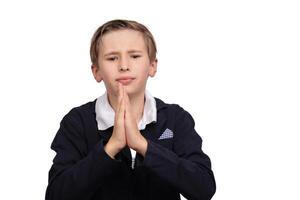 Portrait of a boy asking for something on a white background in close-up. photo