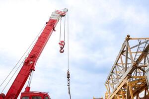 Mobile crane in at construction site with the sky in the background photo