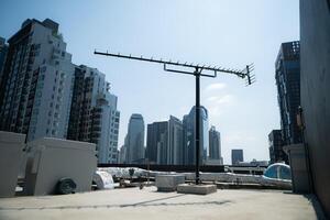 An old television signal antenna in the middle of the city. that still have some to receive signals photo