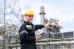 Petroleum engineer is on a mission to inspect oil distillation at a huge oil refinery photo