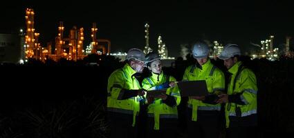 Group of Petroleum engineer is on a mission to inspect oil distillation at a huge oil refinery photo