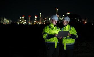 Both of Petroleum engineer is on a mission to inspect oil distillation at a huge oil refinery photo