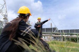Both of Petroleum engineer is on a mission to inspect oil distillation at a huge oil refinery photo