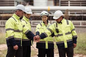 Group of Petroleum engineer is on a mission to inspect oil distillation at a huge oil refinery photo
