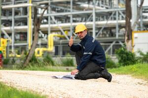 Petroleum engineer is on a mission to inspect oil distillation at a huge oil refinery photo