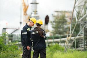 Both of Petroleum engineer is on a mission to inspect oil distillation at a huge oil refinery photo