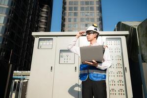Before proceeding with the testing, Electrical engineer inspects the installed control panel. photo