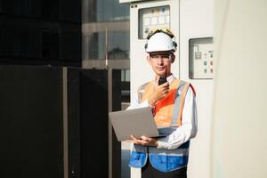 Before proceeding with the testing, Electrical engineer inspects the installed control panel. photo