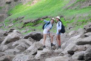 A group of friends going hiking in the streams of the tropical forest area. photo
