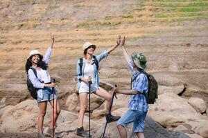A group of friends going hiking in the streams of the tropical forest area. photo